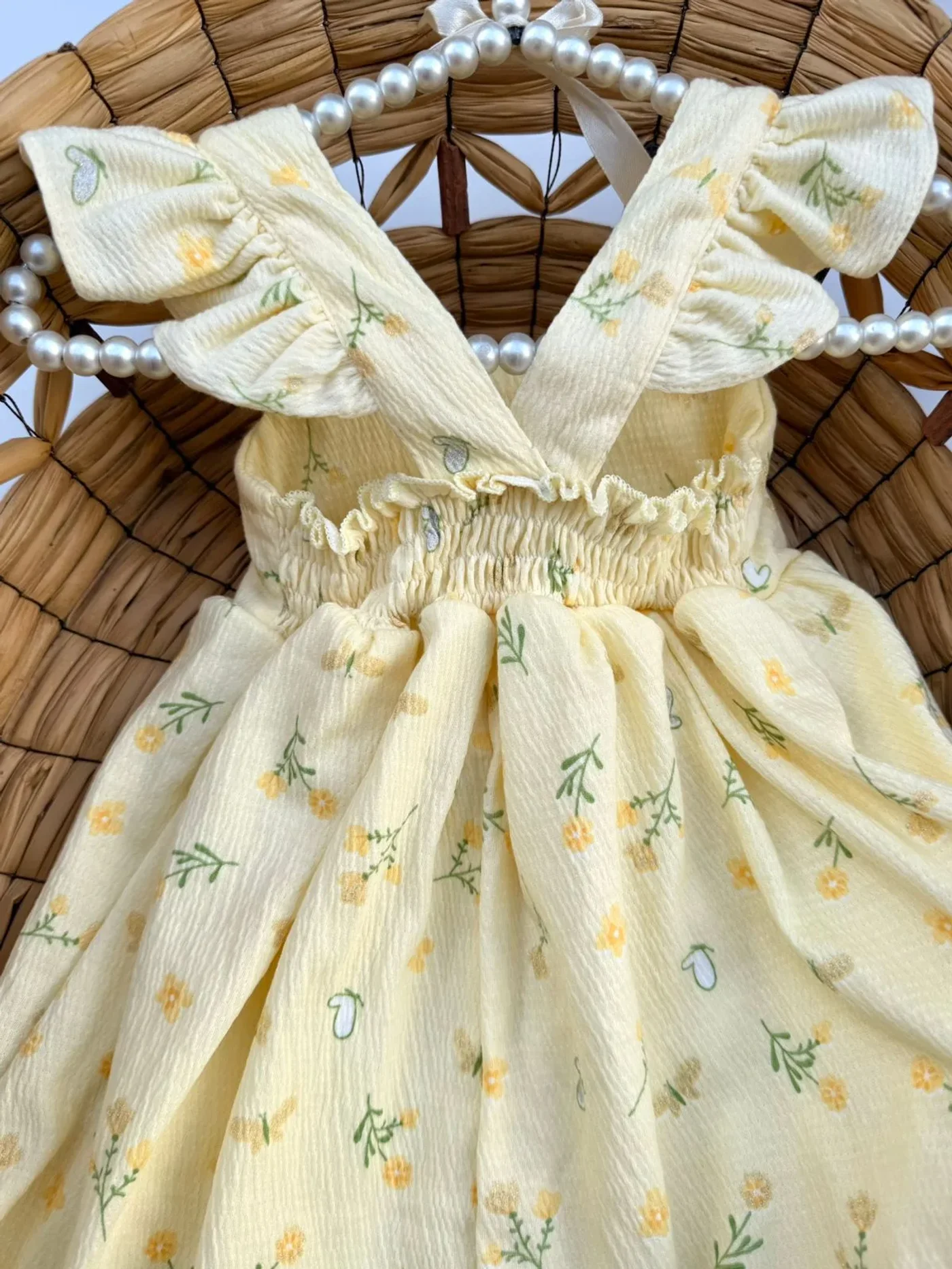 vestido-amarillo-con-pinza-de-flores-para-bebe-nina_babyrex_02_0fd217f6.webp