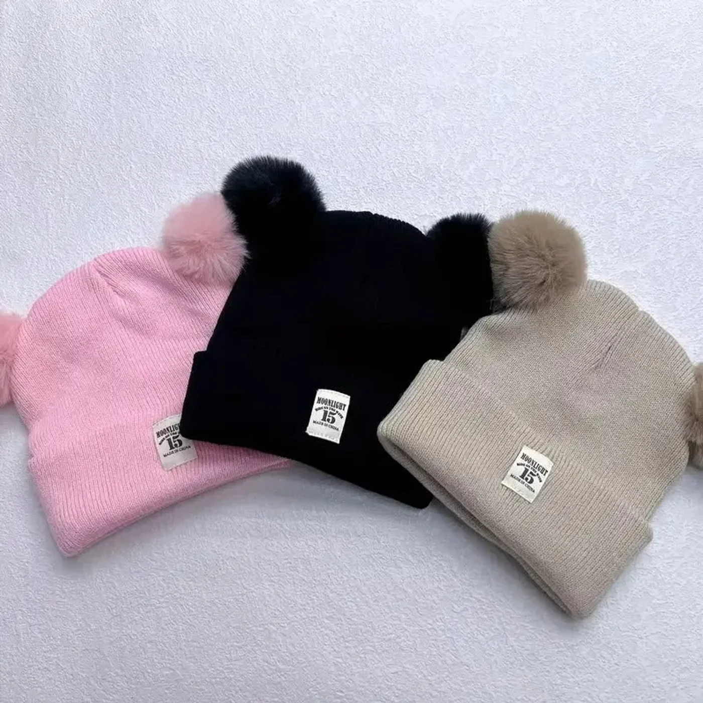 gorro-con-pompones-abrigador-rosado-gris-cafe-negro-para-bebe_babyrex_01_6bfb8f57.webp