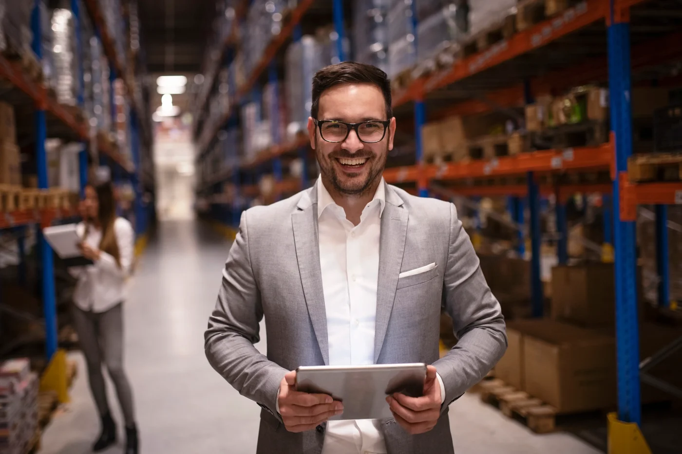 cheerful-successful-middle-aged-manager-businessman-holding-tablet-computer-large-warehouse-organizi.webp